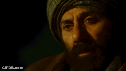 A Man With A Beard Wearing A Turban And A Scarf GIF