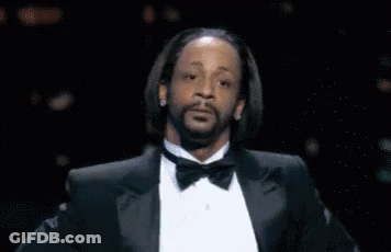 A Man With A Beard Wearing A Tuxedo And Bow Tie Is Making A Funny Face . GIF