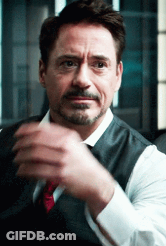 A Man With A Beard Wearing A Vest And Tie Is Clapping His Hands GIF