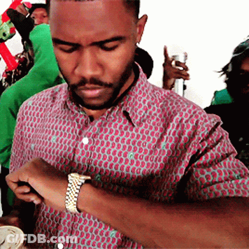 A Man With A Beard Wearing A Watch Looks At His Watch GIF