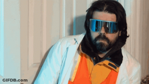 A Man With A Beard Wearing A White Coat And Sunglasses GIF