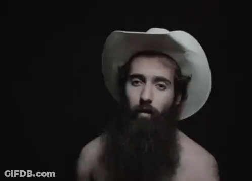 A Man With A Beard Wearing A White Cowboy Hat . GIF