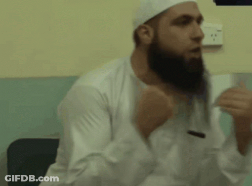 A Man With A Beard Wearing A White Hat And White Shirt GIF