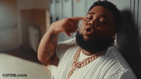 A Man With A Beard Wearing A White Shirt And A Gold Necklace GIF