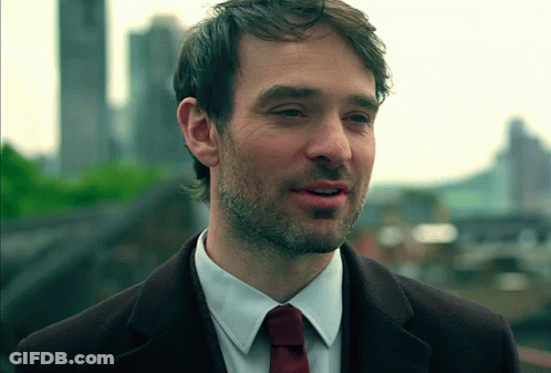 A Man With A Beard Wearing A White Shirt And A Red Tie GIF