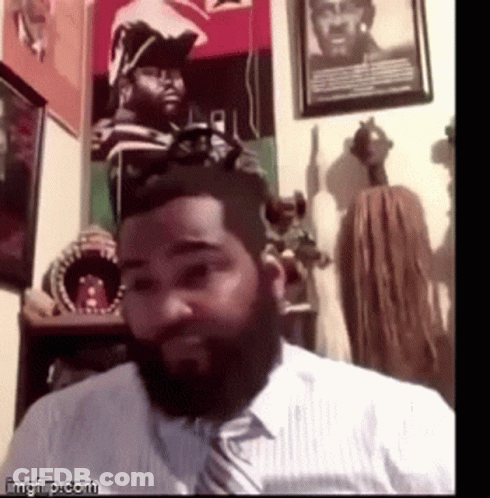A Man With A Beard Wearing A White Shirt And A Tie GIF