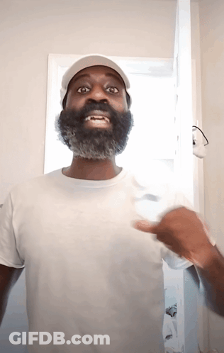 A Man With A Beard Wearing A White Shirt And Hat GIF