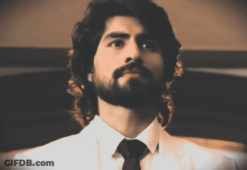 A Man With A Beard Wearing A White Shirt And Tie GIF