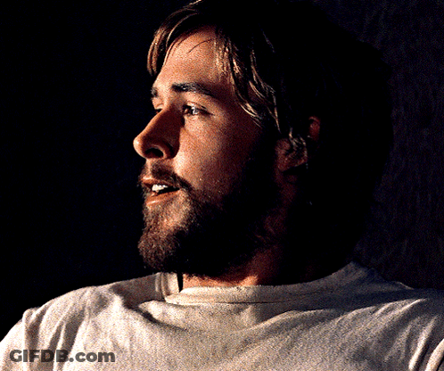 A Man With A Beard Wearing A White Shirt Is Smiling GIF