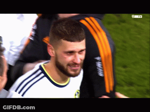 A Man With A Beard Wearing A White Shirt With The Word Adidas On The Sleeve GIF