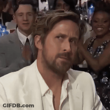 A Man With A Beard Wearing A White Suit And Tie GIF
