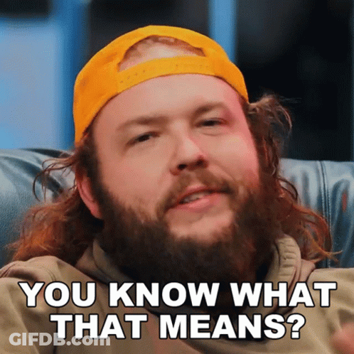 A Man With A Beard Wearing A Yellow Hat Is Asking You Know What That Means GIF