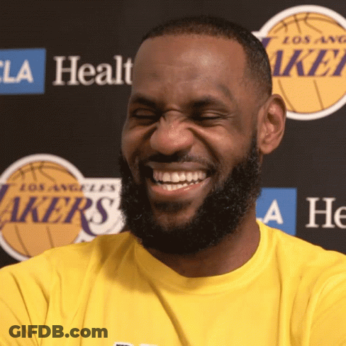 A Man With A Beard Wearing A Yellow Lakers Shirt Smiles GIF