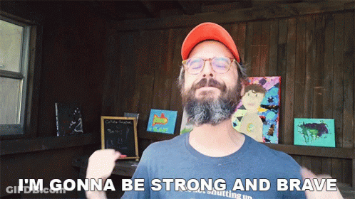 A Man With A Beard Wearing An Orange Hat And Glasses Says I 'M Gonna Be Strong And Brave GIF