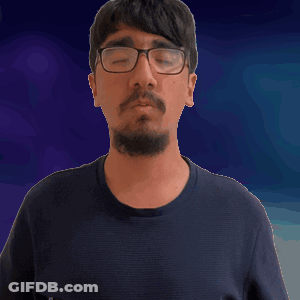 A Man With A Beard Wearing Glasses And A Black Shirt GIF