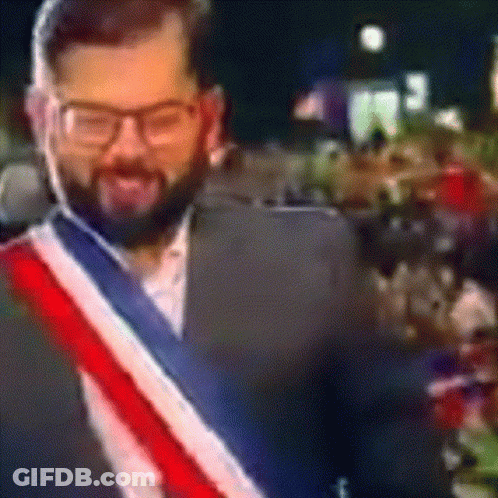 A Man With A Beard Wearing Glasses And A Red White And Blue Scarf GIF