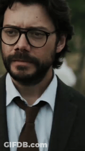 A Man With A Beard Wearing Glasses And A Suit And Tie GIF