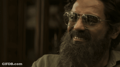 A Man With A Beard Wearing Glasses And Smiling GIF