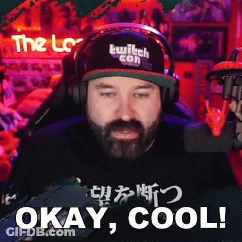 A Man With A Beard Wearing Headphones And A Hat That Says Twitch Con 2022 GIF