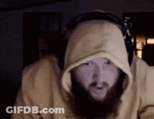 A Man With A Beard Wearing Headphones And A Hooded Sweatshirt GIF