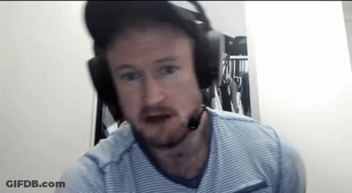 A Man With A Beard Wearing Headphones And A Microphone . GIF