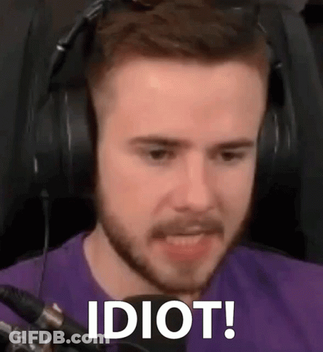 A Man With A Beard Wearing Headphones And A Purple Shirt Is Making A Funny Face . GIF