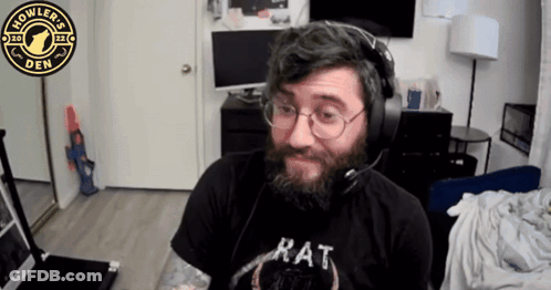 A Man With A Beard Wearing Headphones And A Rat Shirt GIF