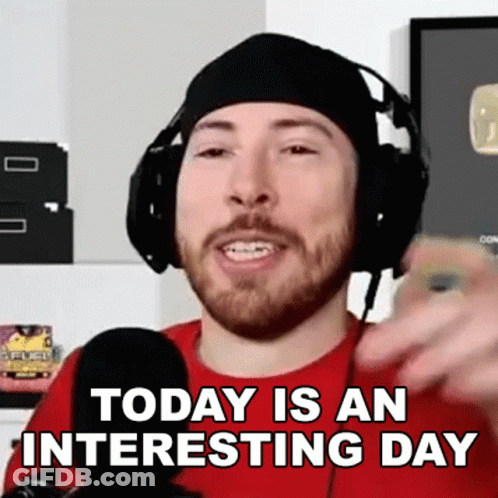 A Man With A Beard Wearing Headphones And A Red Shirt Says Today Is An Interesting Day GIF