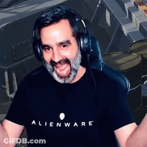 A Man With A Beard Wearing Headphones And An Alienware T-Shirt . GIF