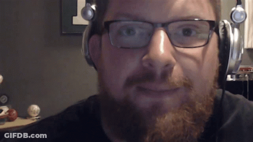 A Man With A Beard Wearing Headphones And Glasses GIF