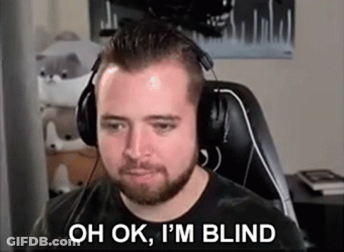A Man With A Beard Wearing Headphones Is Sitting In Front Of A Computer Screen . GIF