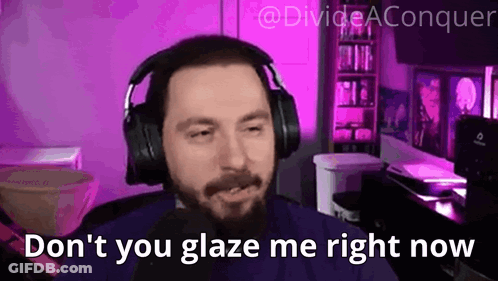 A Man With A Beard Wearing Headphones Is Sitting In Front Of A Microphone In A Purple Room . GIF