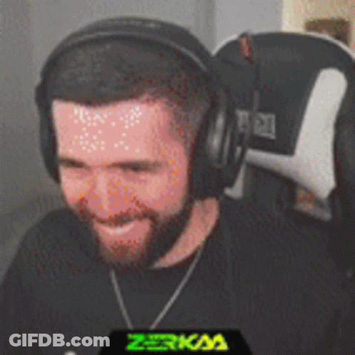A Man With A Beard Wearing Headphones Is Smiling GIF