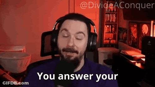 A Man With A Beard Wearing Headphones Is Talking Into A Microphone And Saying `` You Answer Your '' . GIF