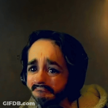 A Man With A Beard Wearing Headphones Making A Face GIF