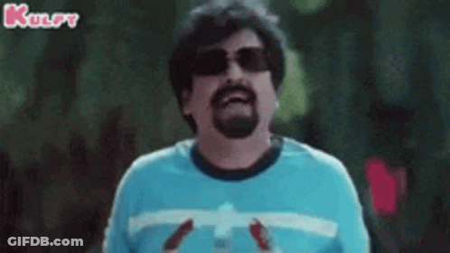 A Man With A Beard Wearing Sunglasses And A Blue Shirt Is Holding A Bottle Of Soda . GIF