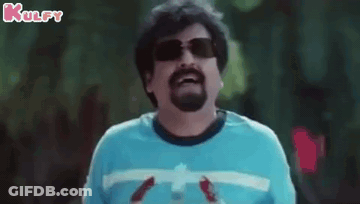 A Man With A Beard Wearing Sunglasses And A Blue Shirt Is Holding A Bottle Of Water . GIF