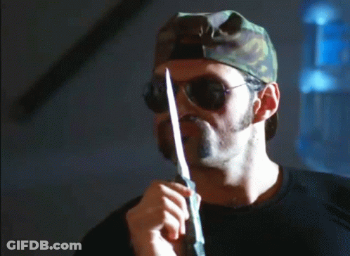 A Man With A Beard Wearing Sunglasses And A Camouflage Hat Says You Never Leave A Man Behind GIF