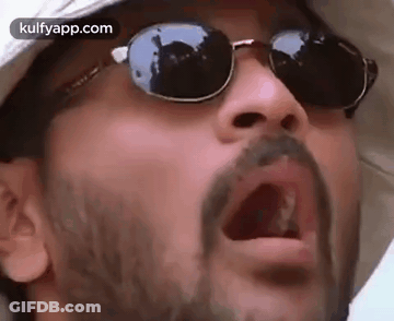 A Man With A Beard Wearing Sunglasses And A Hat . GIF