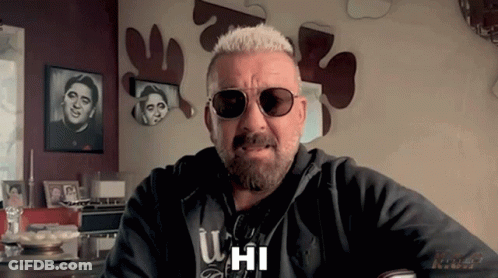 A Man With A Beard Wearing Sunglasses And A Hoodie That Says U Hi GIF