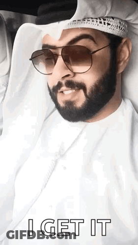 A Man With A Beard Wearing Sunglasses And A Turban Says I Get It . GIF
