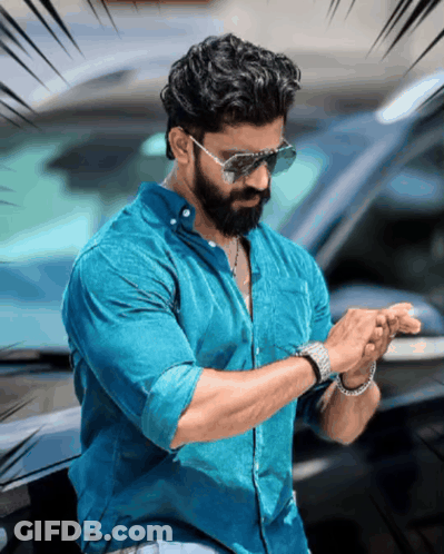 A Man With A Beard Wearing Sunglasses And A Watch Looks At His Watch GIF