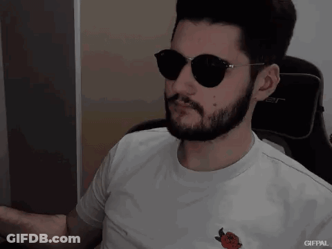A Man With A Beard Wearing Sunglasses And A White Shirt With A Strawberry On It GIF