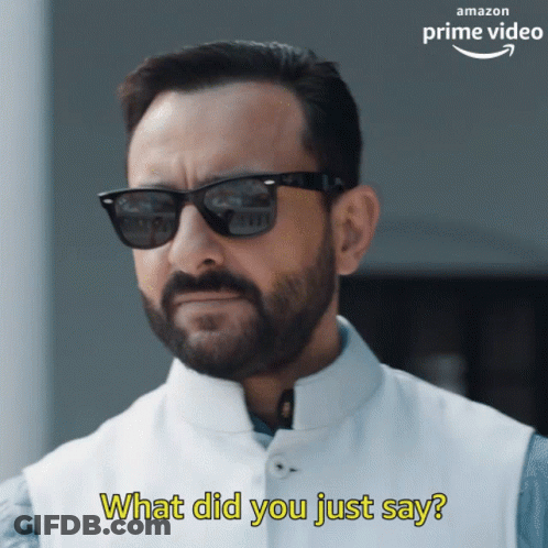A Man With A Beard Wearing Sunglasses And A White Vest Says What Did You Just Say GIF