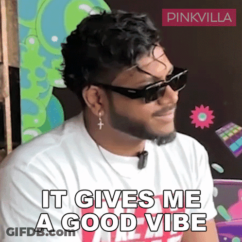 A Man With A Beard Wearing Sunglasses And Earrings Says It Gives Me A Good Vibe GIF