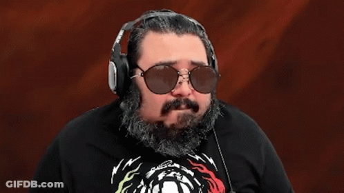 A Man With A Beard Wearing Sunglasses And Headphones With The Word Ok On His Shirt GIF