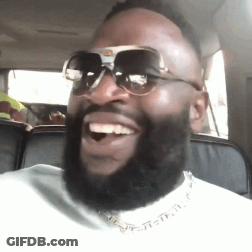 A Man With A Beard Wearing Sunglasses Is Smiling GIF