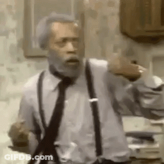 A Man With A Beard Wearing Suspenders And A Tie Is Standing In A Kitchen . GIF