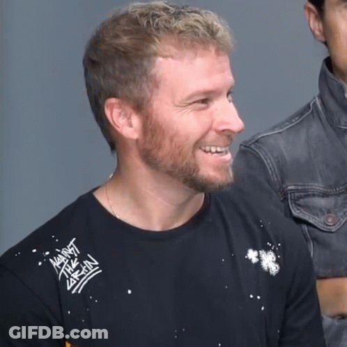 A Man With A Beard Wears A Black Shirt That Says Against Brain GIF