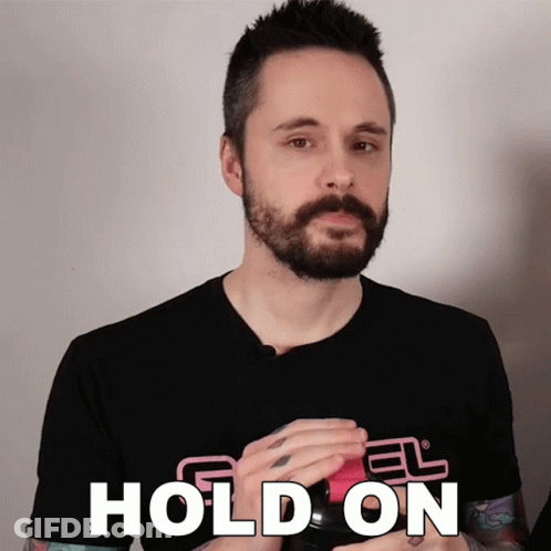 A Man With A Beard Wears A Black Shirt That Says " Hold On " GIF